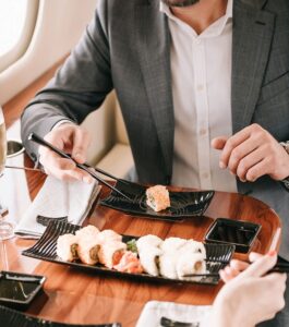 Cropped View Of Businessman And Businesswoman Holding Chopsticks