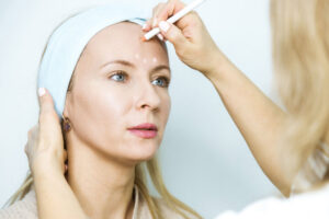 Woman At A Beauticians Appointment. A Specialist Examines It And